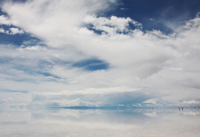 Perfect for travel brochures, nature documentaries, landscape photography websites, or meditation visuals. This expansive salt flat showcasing stunning cloud reflections against a bright blue sky encapsulates serenity and the vast beauty of nature.
