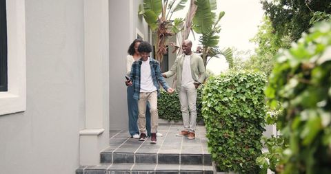 Joyful Family Celebrating on Patio in Lush Garden Surroundings