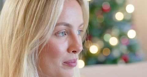 Woman enjoying tranquil holiday season with festive decor