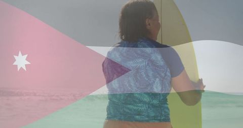 Senior Woman Holding Surfboard Against Jordanian Flag