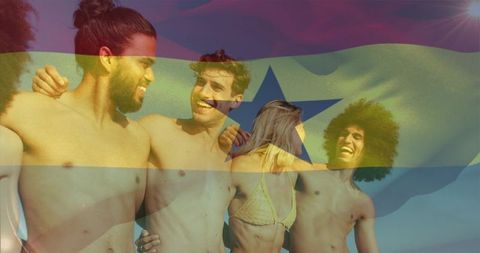 Friends celebrating on beach embracing in swimwear with ghana flag overlay and sun flare