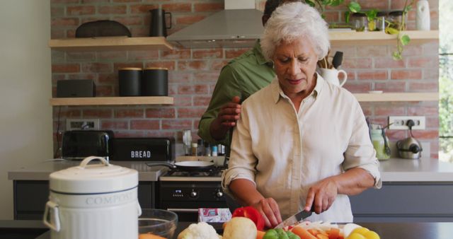 Happy Senior Biracial Couple Embracing While Preparing Food in Modern Kitchen - Download Free Stock Images Pikwizard.com