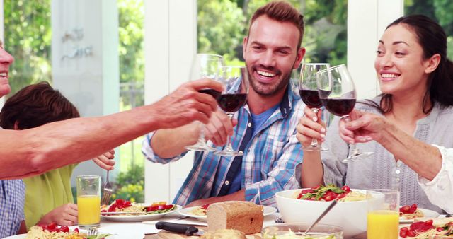 Happy Family Enjoying Meal with Toasting Wine Glasses - Download Free Stock Images Pikwizard.com