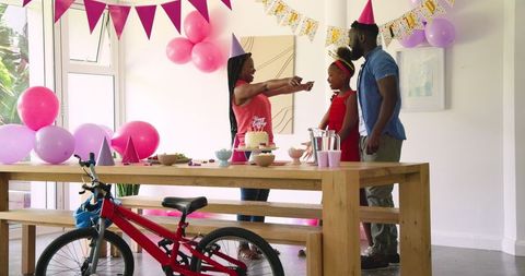 Joyful family birthday celebration with colorful decorations at home