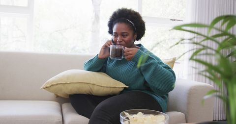 Woman Relaxing at Home Talking on Smartphone with Coffee