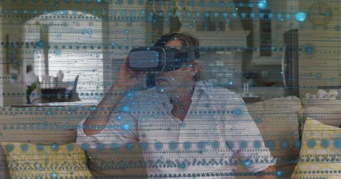 Senior Man Immersed in Virtual Reality in Modern Open-Plan Living Space