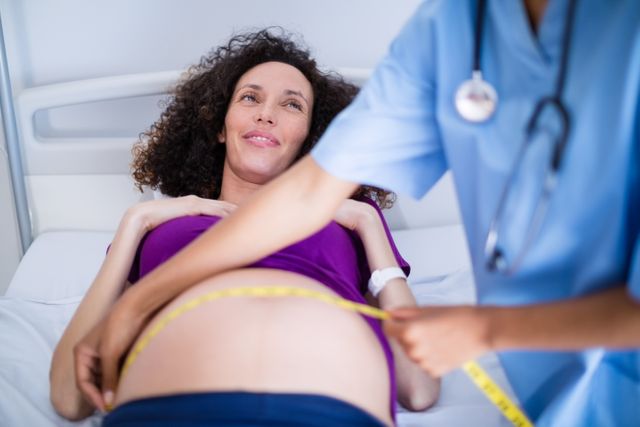 Doctor measuring pregnant womans belly in ward - Download Free Stock Photos Pikwizard.com