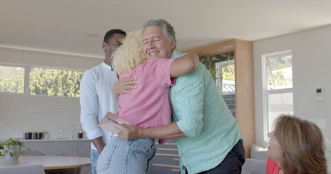 Senior Couple Exchanging Joyful Gifts at Home