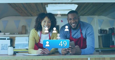 Happy entrepreneurs engaging with social media in food truck