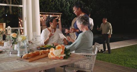 Senior Women Laughing at Outdoor Celebration Gathering
