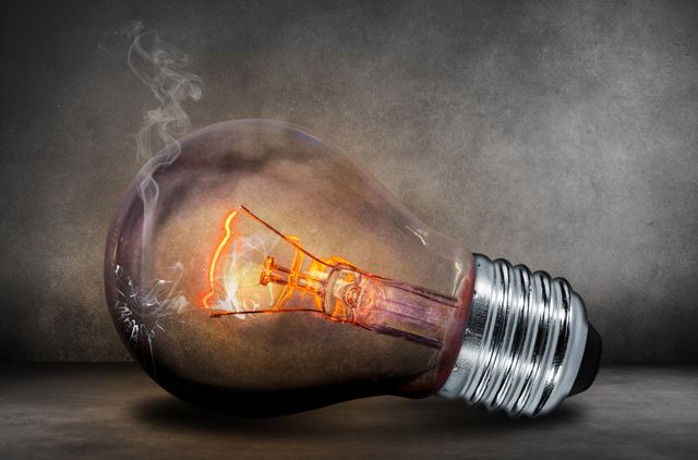 Burning Light Bulb With Smoke Against Dark Background - Download Free Stock Photos Pikwizard.com