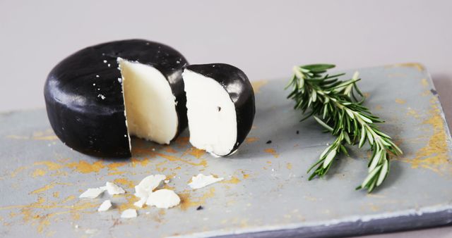 Round Black Cheese Wheel With Slice and Fresh Rosemary - Download Free Stock Images Pikwizard.com