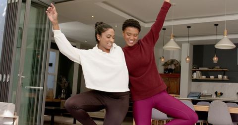 Diverse Friends Practicing Yoga Poses at Home