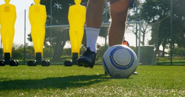 A soccer player prepares to kick the ball on the field - Download Free Stock Photos Pikwizard.com