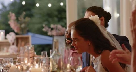 Joyful Wedding Reception Dinner with Guests Engaging in Laughter