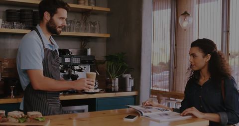 Barista and Customer in Modern Coffee Shop
