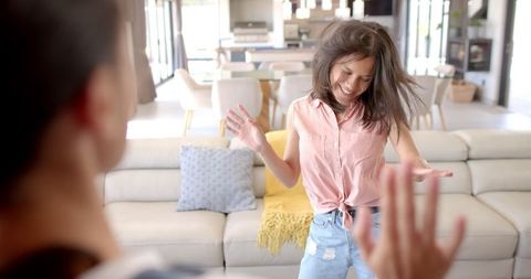 Young Woman Dancing Joyfully at Home