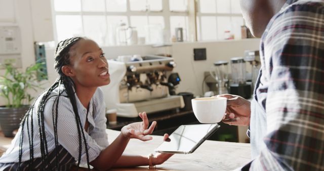 Friendly Conversation at Coffee Shop Counter - Download Free Stock Images Pikwizard.com