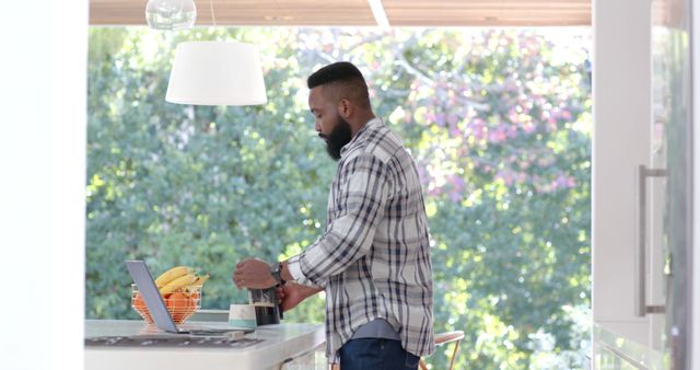 Man in Modern Kitchen Preparing Coffee by Large Window - Download Free Stock Images Pikwizard.com