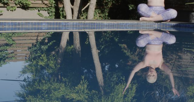 Woman Practicing Yoga By Reflective Pool Outdoors - Download Free Stock Images Pikwizard.com