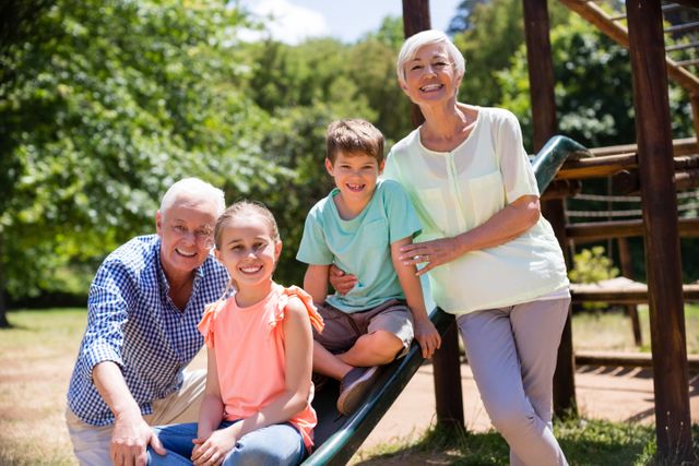 Grandparents enjoying a sunny day in the park with their grandchildren. Perfect for illustrating family bonding, outdoor activities, and intergenerational relationships. Ideal for use in family-oriented advertisements, brochures, and websites promoting outdoor fun and family values.