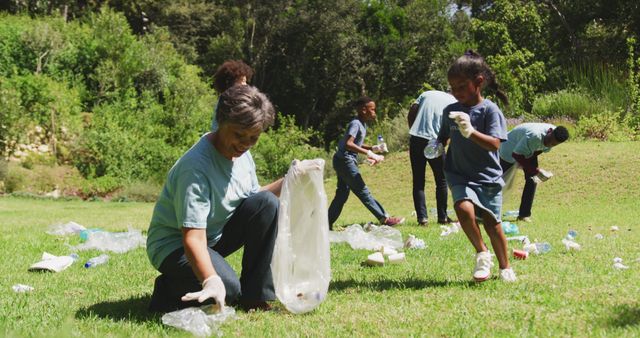 Group of volunteers consisting of adults and children are picking up litter in a park to promote environmental conservation. They wear gloves and use garbage bags to collect trash scattered across the grass. This scene represents teamwork, community service, and dedication to maintaining a clean environment. Ideal for campaigns focused on environmental awareness, community involvement, volunteer recruitment, and nature conservation efforts.