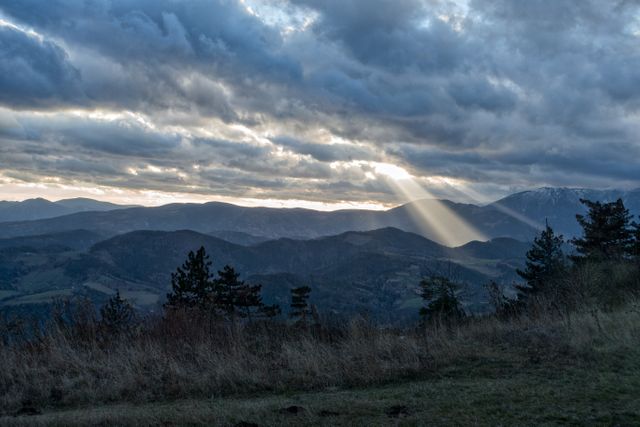 Dramatic Sunbeam Breaking through Clouds over Mountain Landscape - Download Free Stock Photos Pikwizard.com