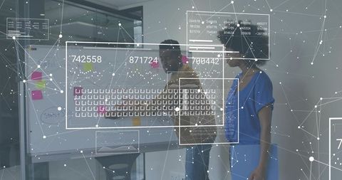 Colleagues collaborating at glass whiteboard with augmented data overlay for tech strategy