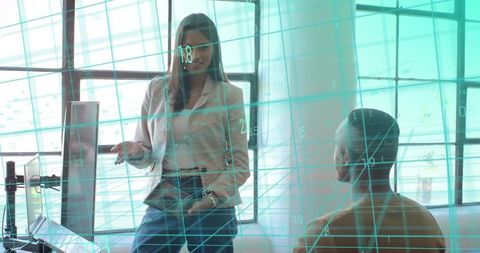 Businesswoman presenting data visualization with teal grid in modern office meeting