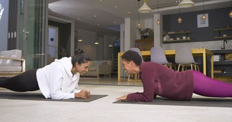 Diverse Female Friends Exercising Together at Home