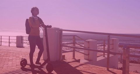 Woman Standing Seaside With Electric Scooter On Promenade
