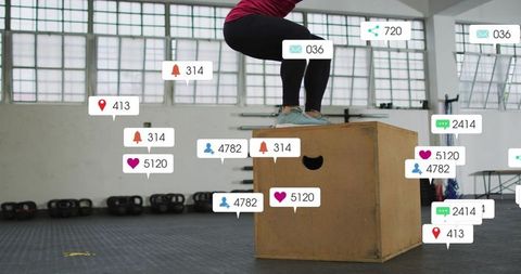 Mid-adult woman balancing on plyo box training with social media engagement overlays in gym