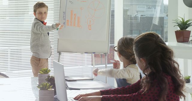 Young Boy Giving Presentation to Classmates in Modern Office Setting - Download Free Stock Images Pikwizard.com