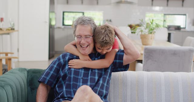 Grandfather Enjoying Quality Time with Grandson on Family Sofa - Download Free Stock Images Pikwizard.com