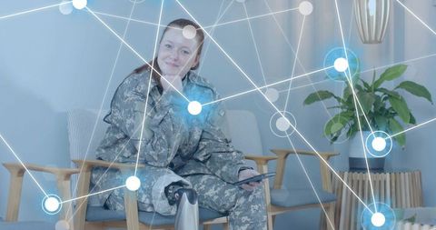 Soldier with Prosthetic Leg Using Technology in Lounge Space