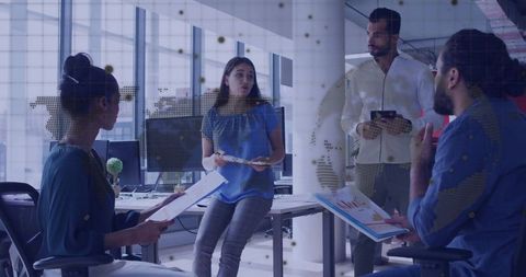 Multicultural Team Collaborating with Charts in Modern Office