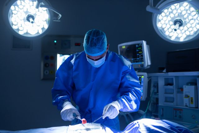 Male surgeon performing operation in operating room at hospital - Download Free Stock Photos Pikwizard.com