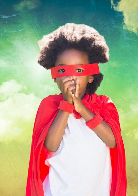 Young child dressed as a superhero standing against a backdrop of a greenish-blue cloudy sky. Ideal for promotional materials related to childhood imagination, playful activities, early years development, and foster care branding.