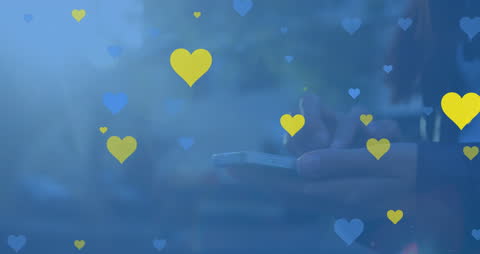 Hands Holding Smartphone Surrounded by Floating Hearts