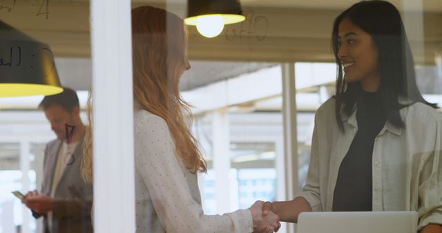 Businesswomen Shaking Hands in Modern Office Environment - Download Free Stock Images Pikwizard.com