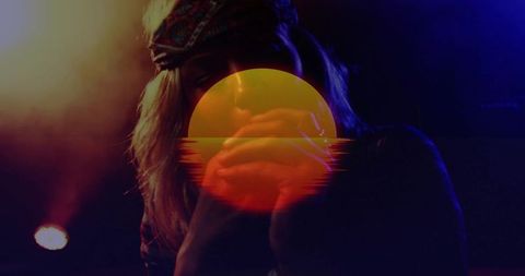 Moody club vocalist silhouette wearing bandana performing with retro sun graphic overlay