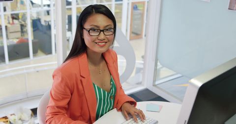 Smiling Young Businesswoman Engaged in Office Work - Download Free Stock Images Pikwizard.com