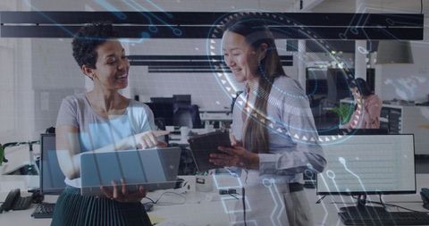 Women collaborating with technology in modern office