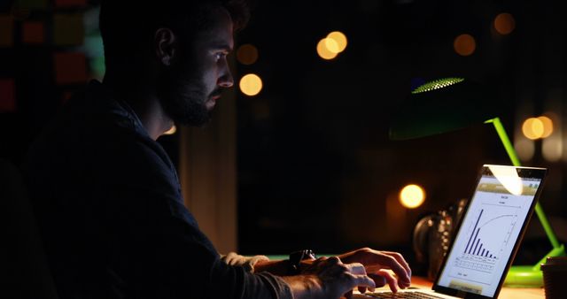 Man Working Late on Laptop Analyzing Data in Low Light Environment - Download Free Stock Images Pikwizard.com