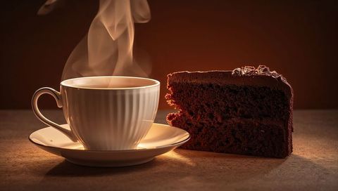 Steaming porcelain cup pairing with decadent chocolate cake slice on warm moody tabletop