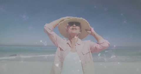 Senior Woman Enjoying Sunny Beach Day in Stylish Attire