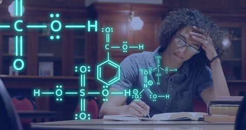 Student Analyzing Chemical Formulas in Library