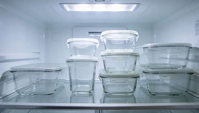 Organizing refrigerator with clear glass food storage containers and white snap lids