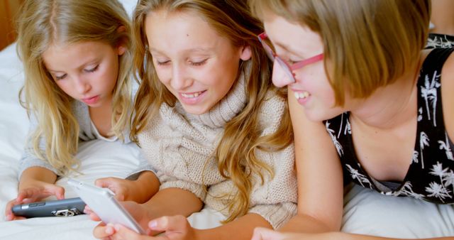 Happy Children with Smartphones Enjoying Technology on Bed - Download Free Stock Images Pikwizard.com