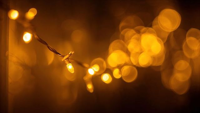 Warm golden string lights with soft bokeh glow for festive outdoor porch ambience